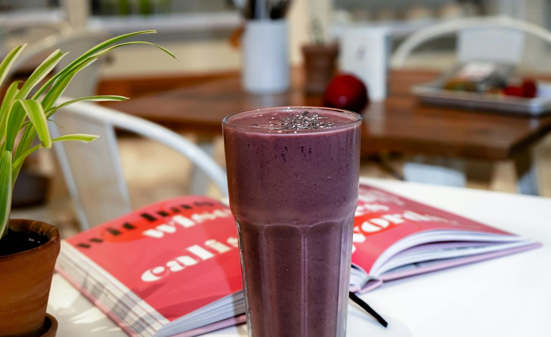 The 2024 Guide to Adaptogenic Smoothies: Stress Relief, Hormonal Balance, and Wellness for Women A woman enjoying a smoothie made with adaptogenic herbs, supporting stress relief and hormonal balance.