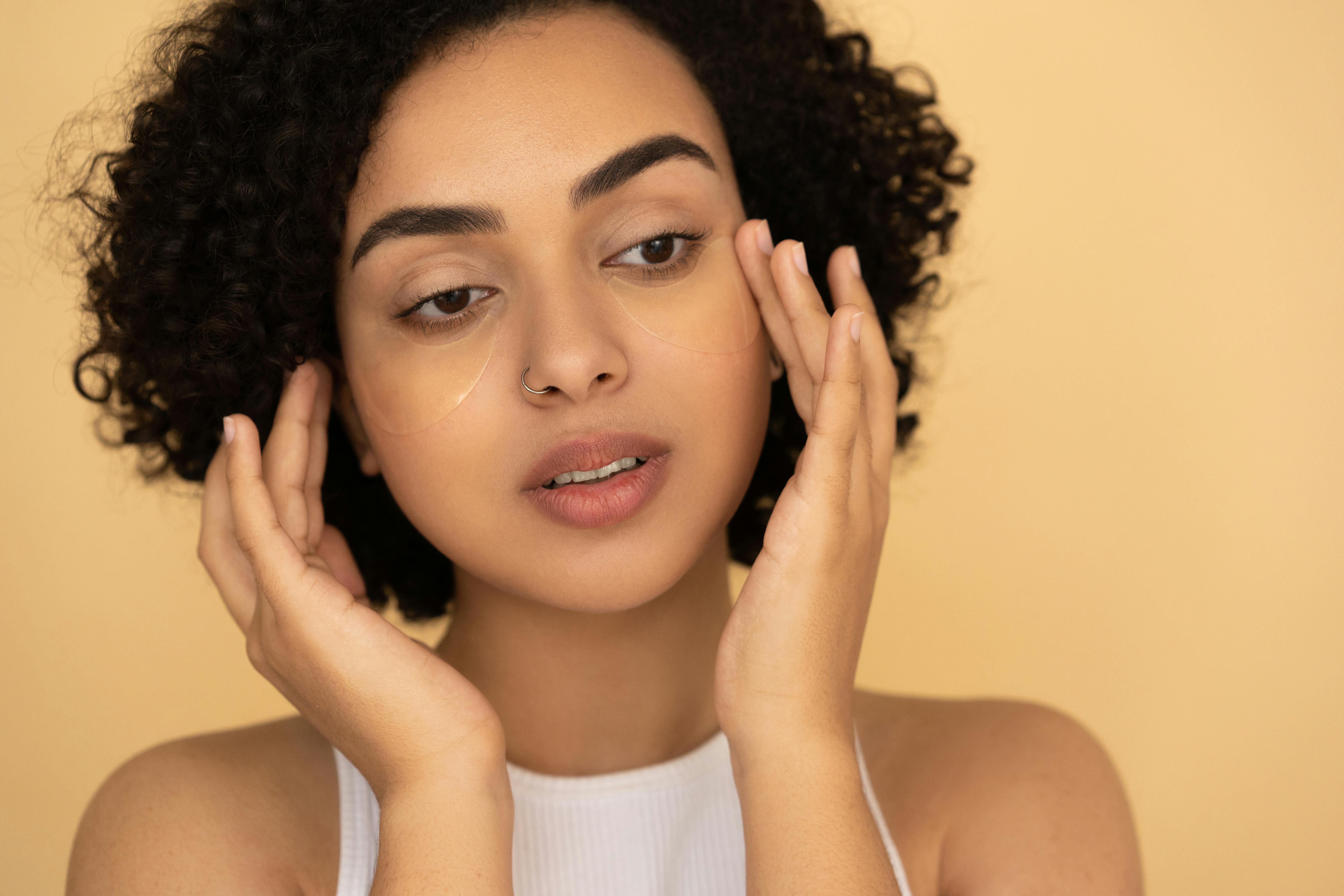 The Benefits of Collagen for Skin - How Intermittent Fasting Enhances Beauty. Woman admiring her glowing skin after using collagen supplements during intermittent fasting.