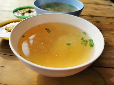 Bone Broth and Collagen - Integrating Natural Supplements in Intermittent Fasting Plans. Steaming bowl of bone broth, rich in natural collagen, suitable for intermittent fasting eating windows.