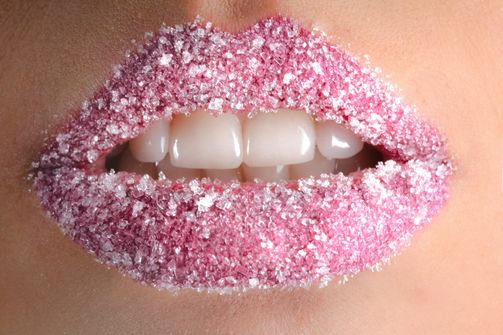 The Sweet Temptation: Understanding Sugar Cravings in Intermittent Fasting Close-up of a woman's lips dusted with sugar, symbolizing cravings during intermittent fasting.