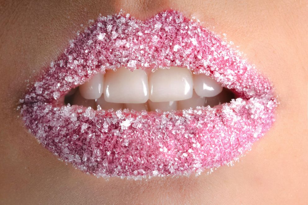 The Sweet Temptation: Understanding Sugar Cravings in Intermittent Fasting Close-up of a woman's lips dusted with sugar, symbolizing cravings during intermittent fasting.