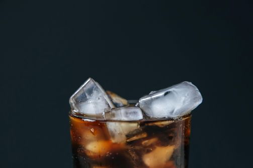 Coke Zero and Intermittent Fasting - Does It Compromise Your Fast? A glass of Coke Zero during fasting hours, symbolizing the debate on fasting and zero-calorie drinks