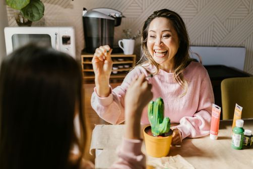 The 2024 Guide to Female Friendships: How Strong Social Bonds Improve Longevity and Health A group of women sharing a moment of joy and connection, supporting each other for better emotional and physical health.