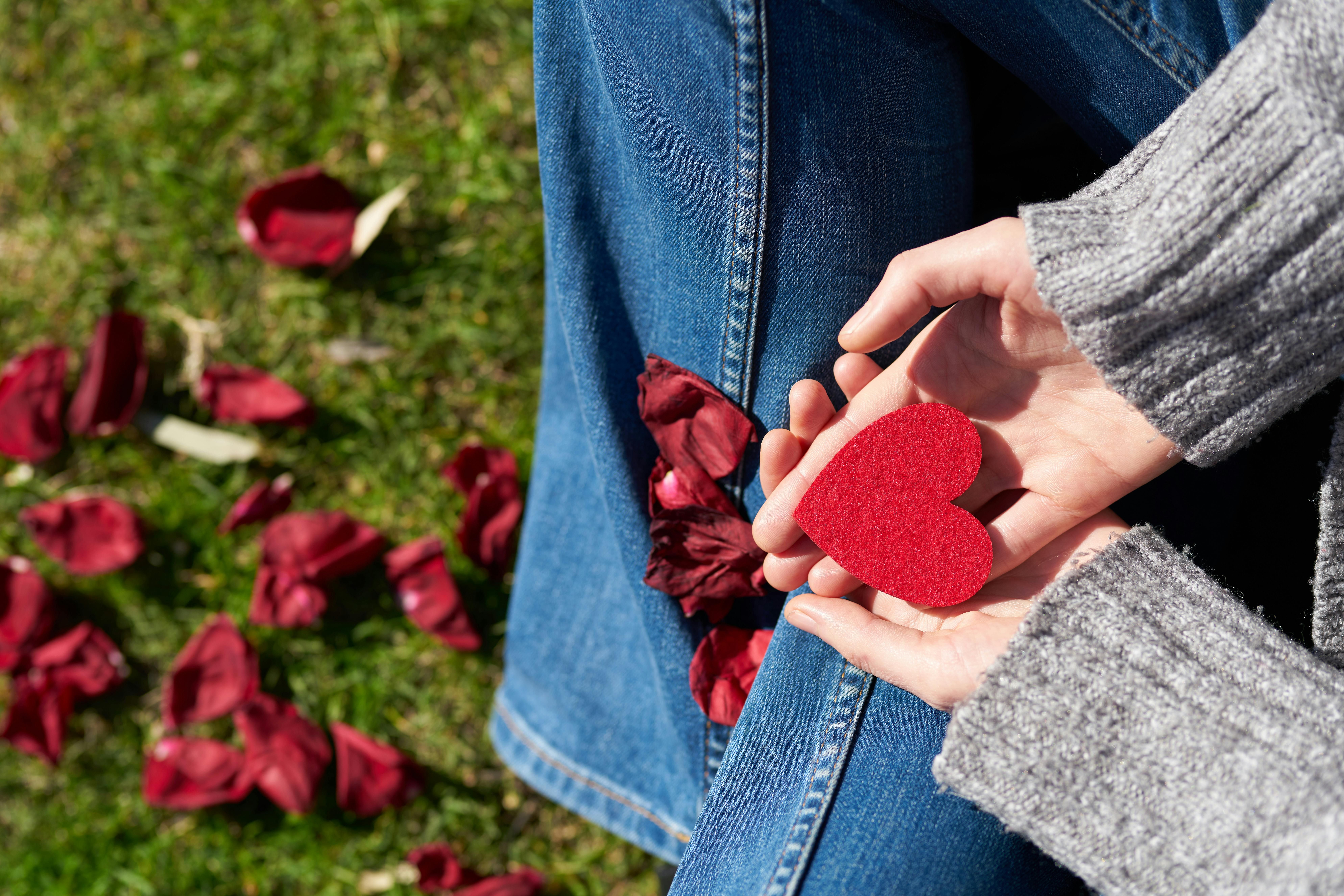 Woman Holding a Paper Heart: Symbol of Heart Health and Recovery A woman holding a paper heart symbolizing a healthy heart and recovery after a heart attack