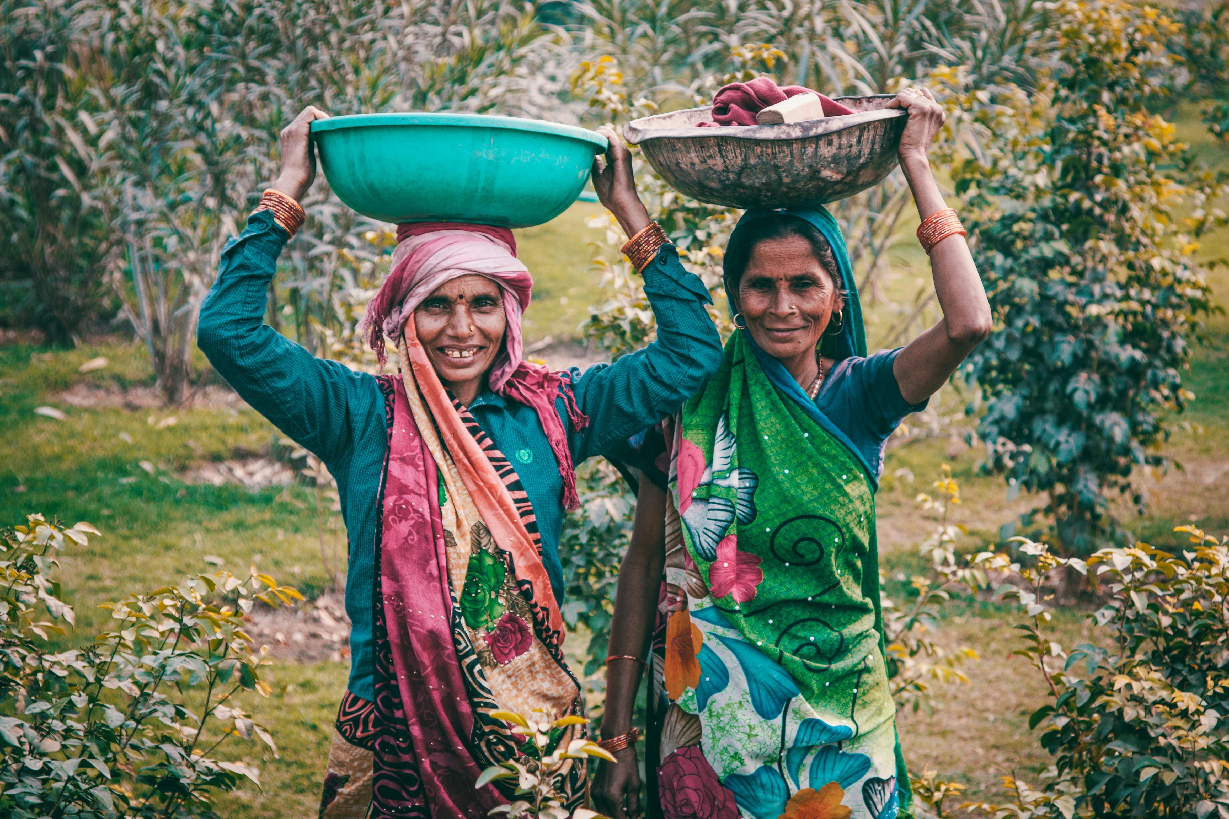 Indian Women Embracing Cultural Traditions: Adapting the Carnivore Diet in a Predominantly Vegetarian Society Two Indian women performing outdoor chores, reflecting traditional lifestyle while exploring different cultural approaches to the carnivore diet.