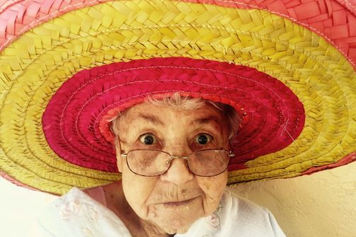 Older lady in a colored hat enjoys her active longevity Older happy lady enjoys longevity