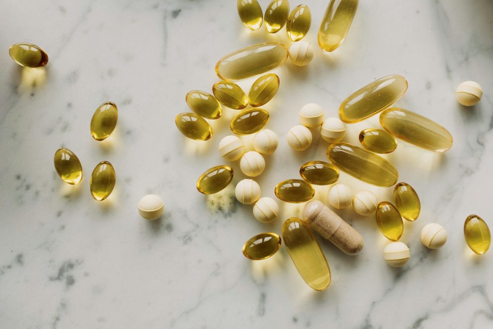 Navigating Omega-3 Supplement Side Effects: A Closer Look Omega-3 supplement capsules and bottle on a surface