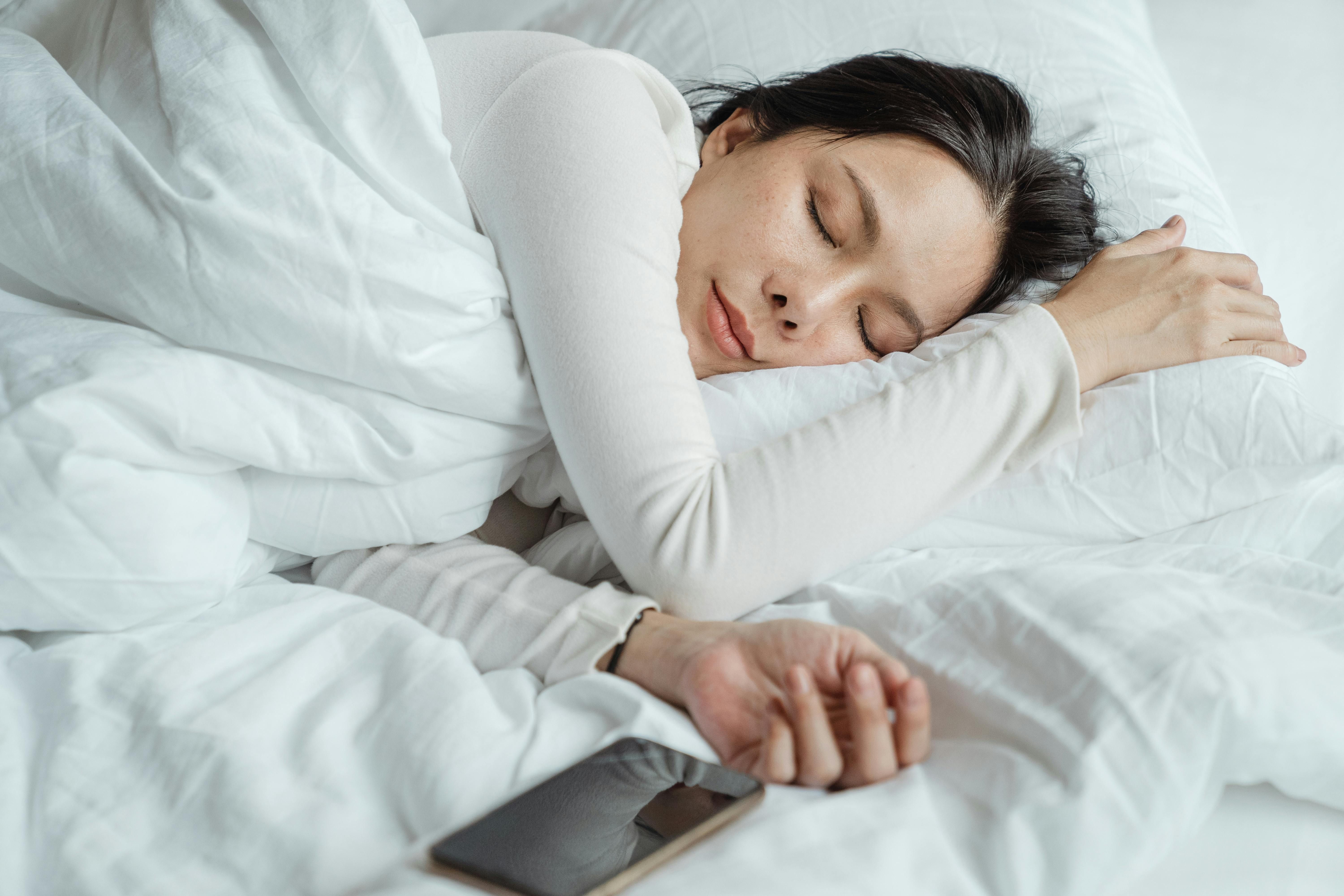 Understanding the Impact of Fasting on Sleep: Tips and Insights Peaceful woman sleeping, illustrating the importance of sleep during fasting periods