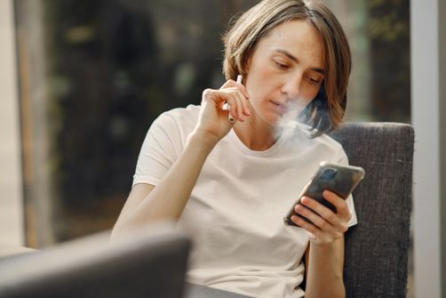 The Dangers of Vaping for Women in 2024: Health Risks and Facts A woman experiencing the harmful effects of vaping, highlighting risks like lung damage, reproductive health issues, and heart disease.
