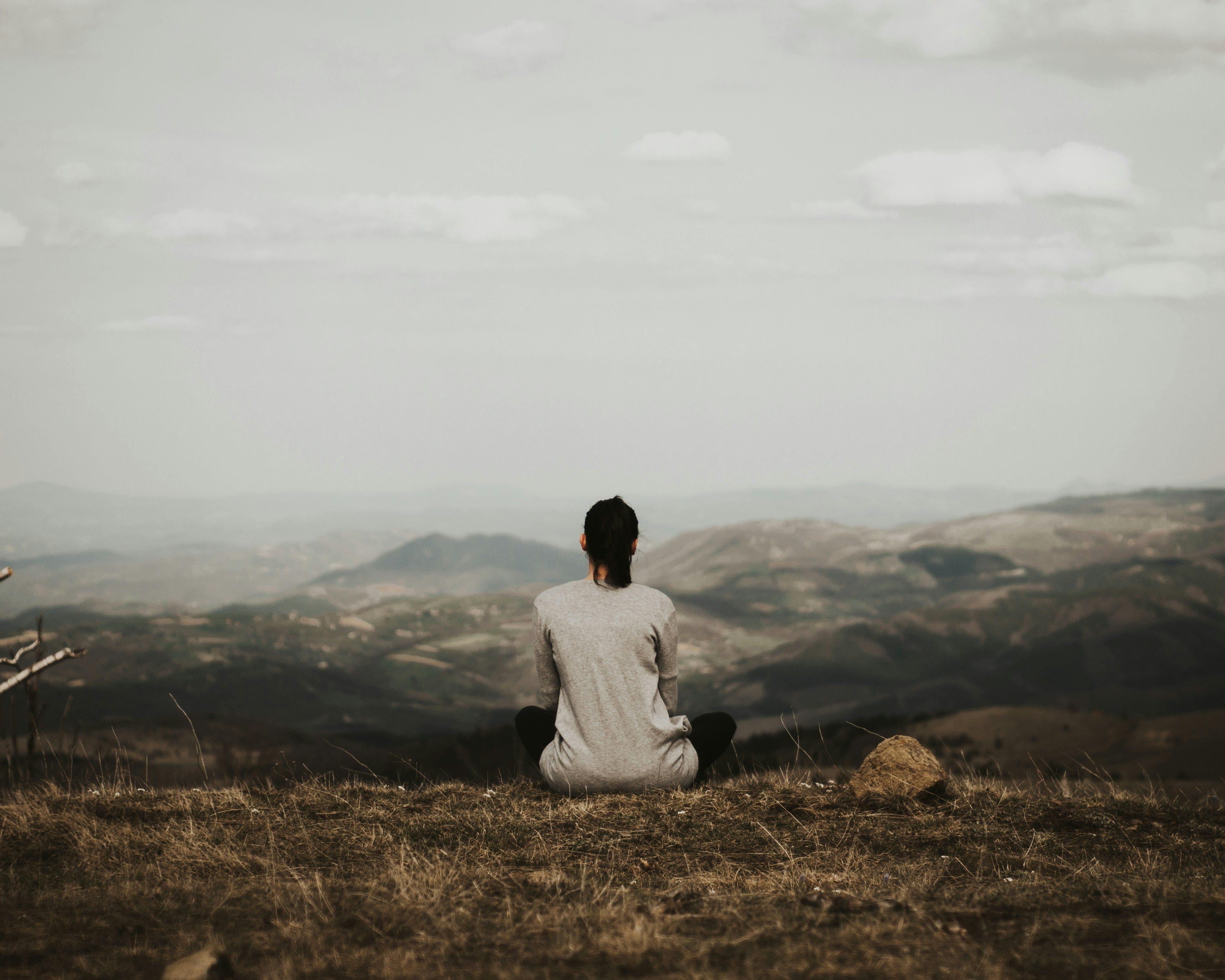 Woman Meditating in Solitude: Harnessing Liminal Spaces for Personal Growth and Emotional Clarity A woman meditating alone, embracing solitude for emotional clarity and personal transformation.