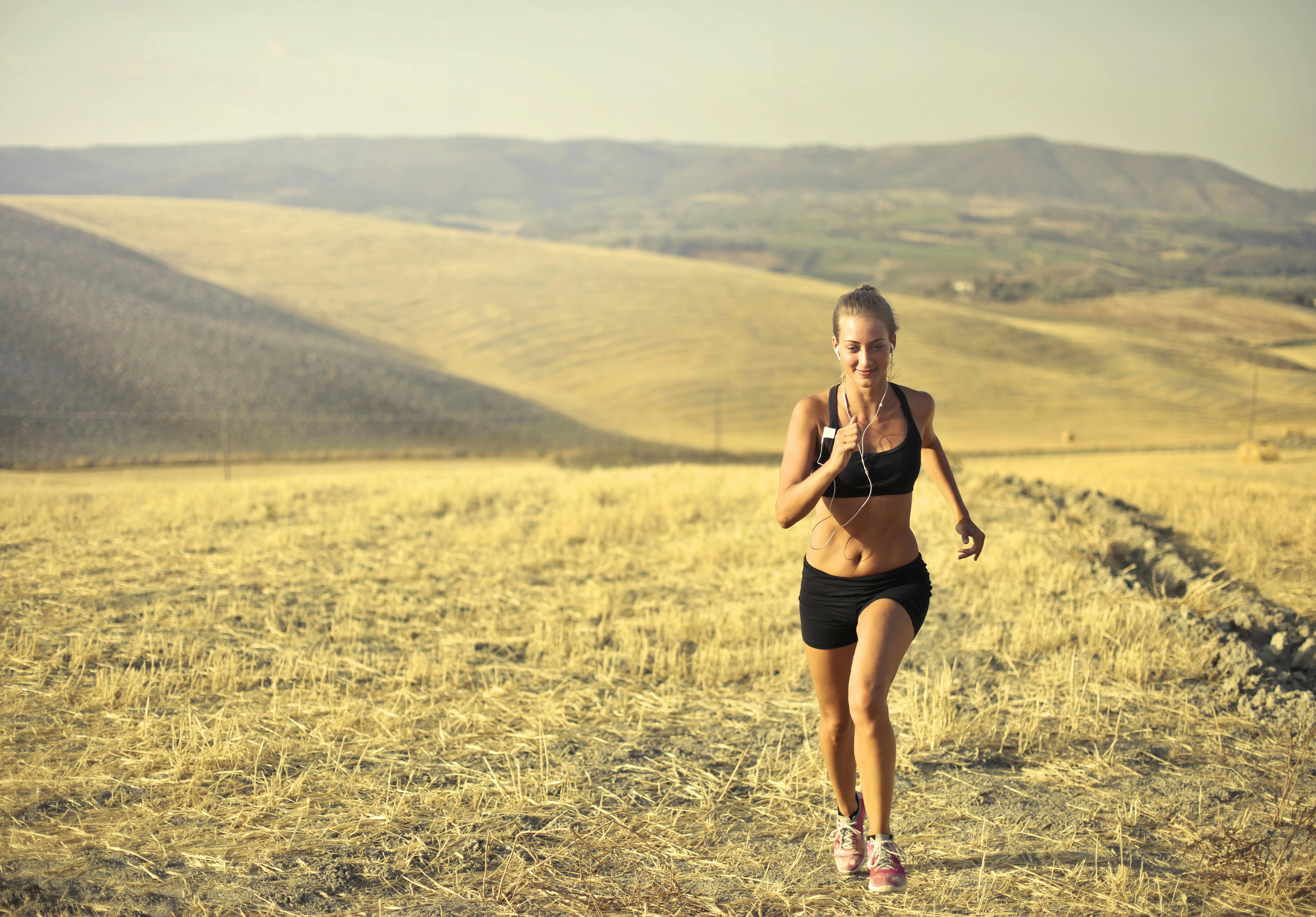 Cardio Training for Women Over 50: Benefits of Running for Heart Health and Fitness A woman running outdoors, focusing on cardiovascular health and fitness.