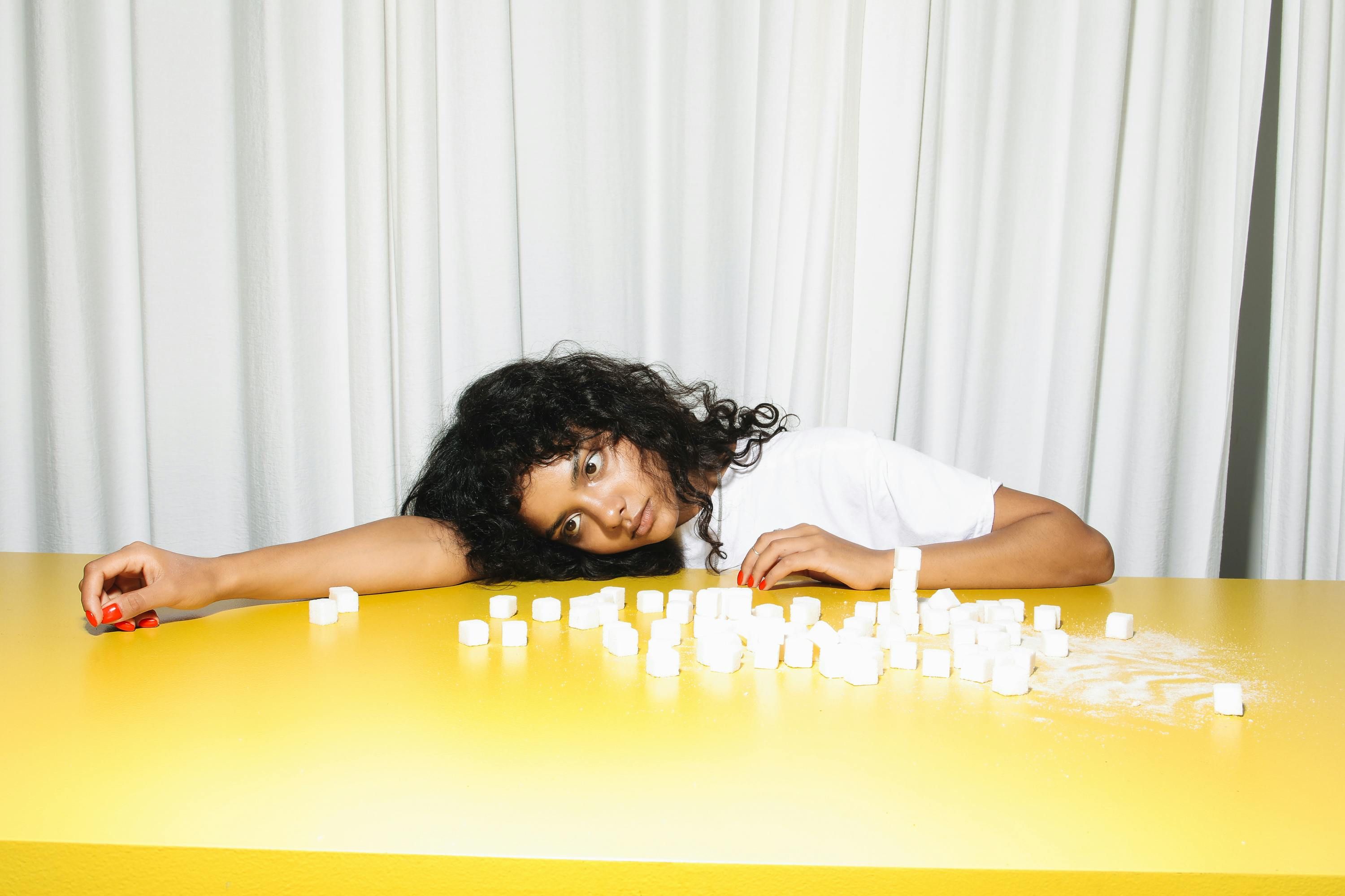 Woman with Diabetes Contemplating Dietary Choices for Blood Sugar Management A woman with diabetes considering her dietary options for managing blood sugar levels.